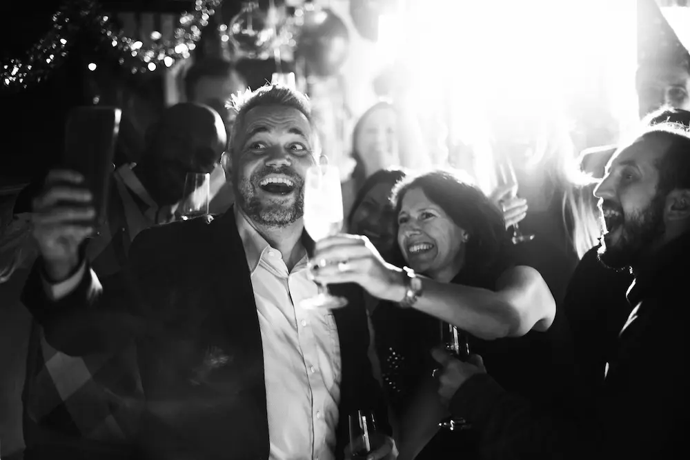 Wedding guests celebrating together at the reception